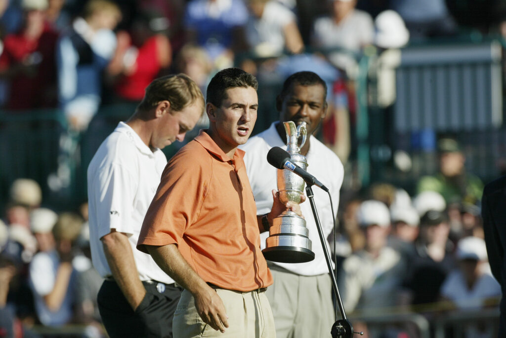 Ben Curtis of the USA receives the claret jug as runners up Thomas Bjorn and Vijay Singh look on after victory