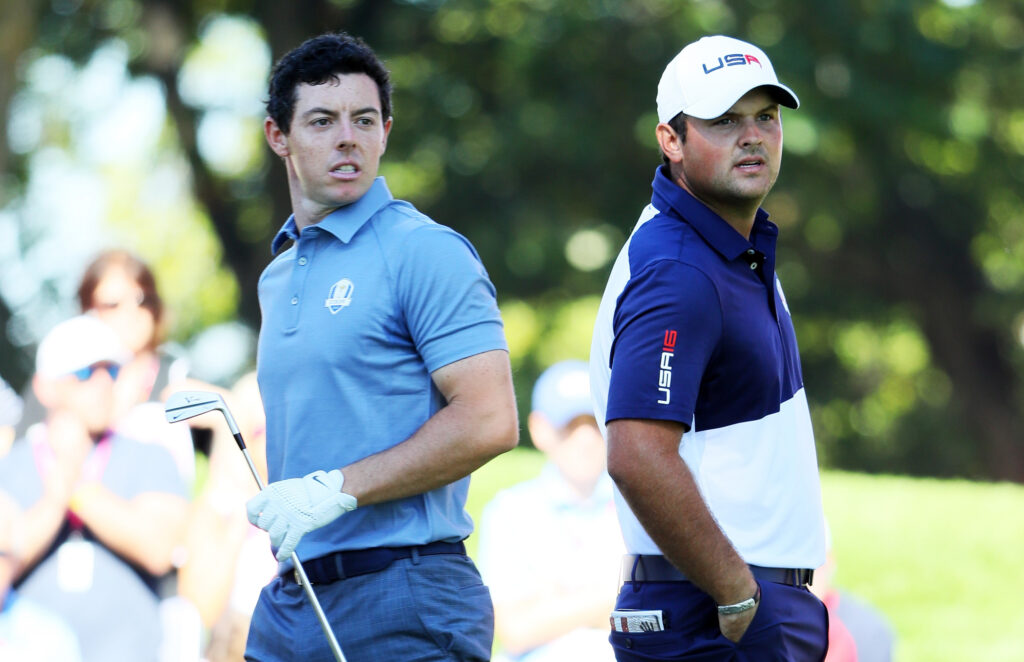 Rory McIlroy of Europe and Patrick Reed of the United States look on from the fourth tee during singles matches of the 2016 Ryder Cup at Hazeltine National Golf Club